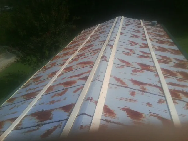 Rusted metal roof panels with new wood purlins before replacement — Storm Damage Roof Repair in Towaco by Roofing Brothers